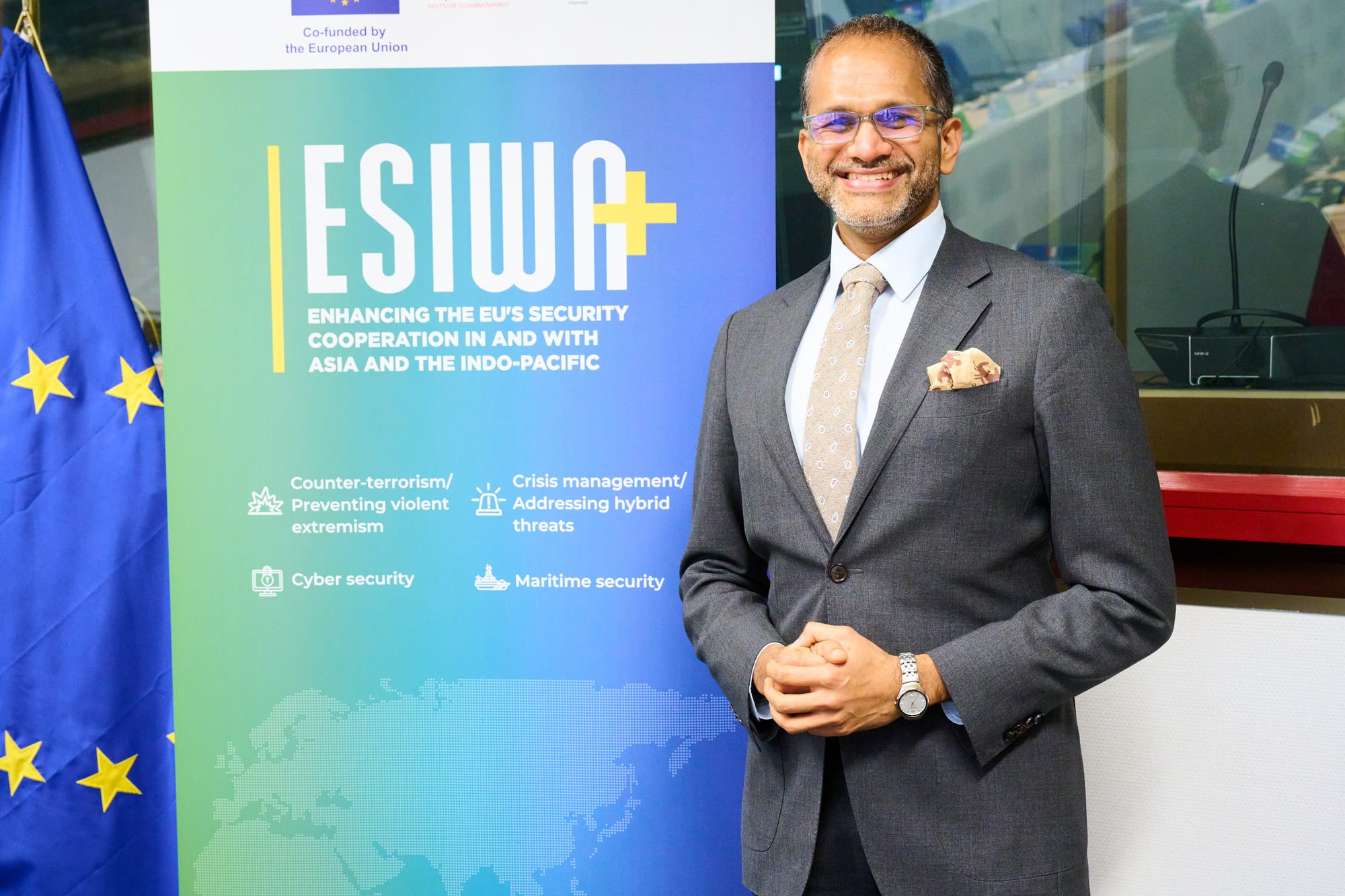 Rahul Venkit standing in front of an ESIWA+ event backdrop
